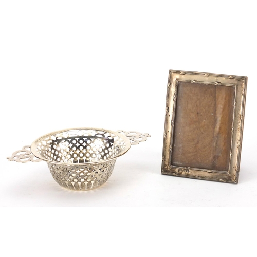 2400 - Circular silver twin handled bon bon dish and rectangular silver easel photo frame, both with Birmin... 