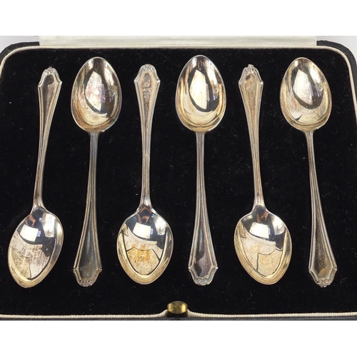 2417 - Two sets of six silver teaspoons, Birmingham and London hallmarks, both housed in velvet and silk li... 