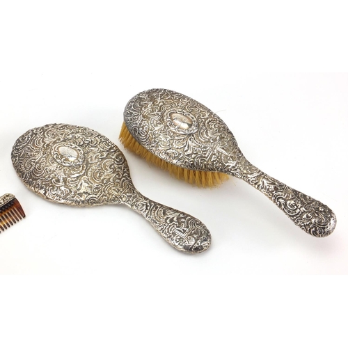 2416 - Victorian silver four piece dressing table set including hand mirror, profusely embossed with flower... 