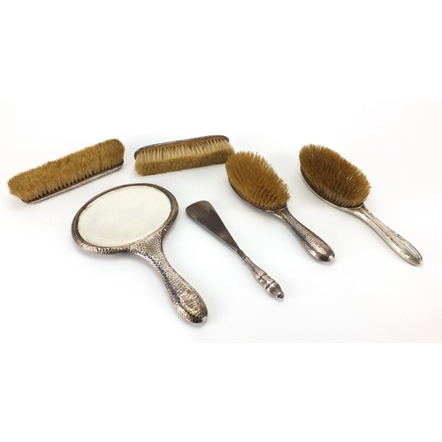 2412 - Silver four piece dressing table set and two others, various hallmarks, the largest 29cm in length