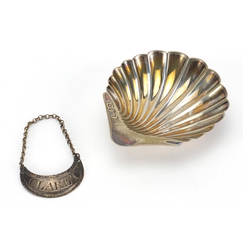 2382 - Silver and three footed shell shaped dish and Georgian claret decanter label, the dish 9.5cm in leng... 