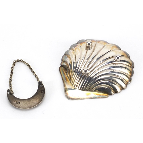 2382 - Silver and three footed shell shaped dish and Georgian claret decanter label, the dish 9.5cm in leng... 