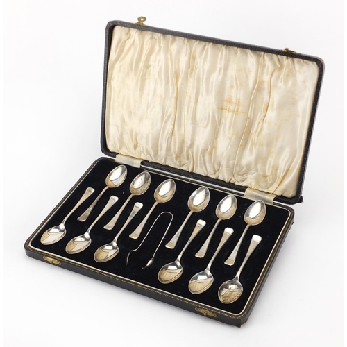 2397 - Set of twelve silver teaspoons and sugar tongs, SLD Birmingham 1939, housed in a velvet and silk lin... 
