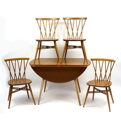 2005 - Ercol light elm drop leaf dining table and four candlestick dining chairs, each chair 80cm high
