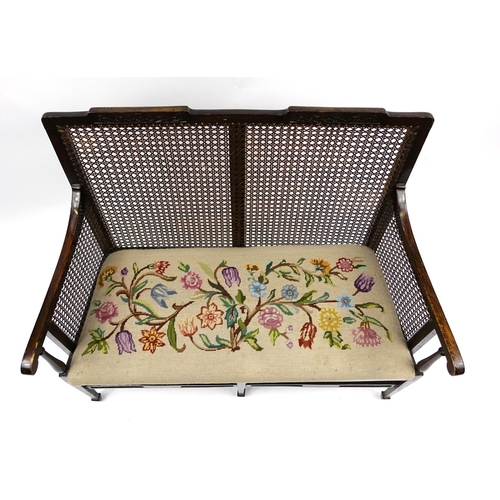 2021 - Mahogany framed bergère three piece salon suite, with needlepoint stuff over seats, the settee 102cm... 