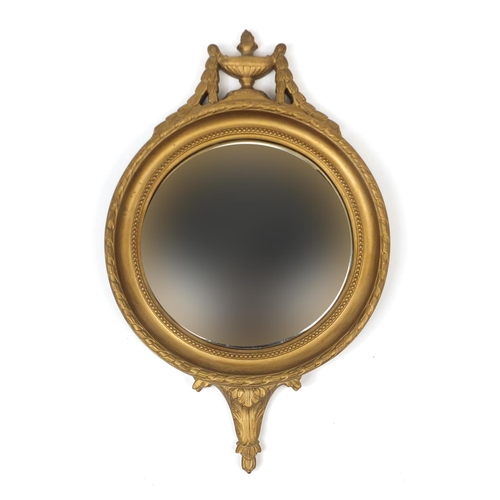 2019 - Gilt circular convex mirror with urn decoration, 64cm high