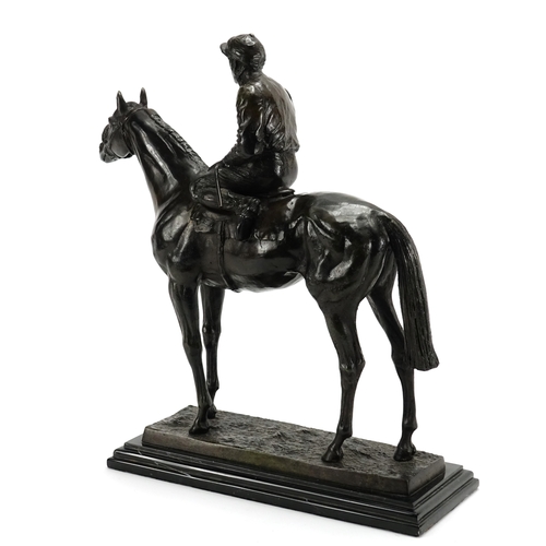 2120 - Bronze study of a jockey on horseback, raised on a rectangular black marble base, 33.5cm high