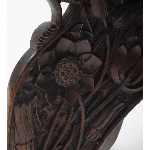 2024 - Anglo Indian folding table profusely carved in relief with flowers, 53cm high x 62cm in diameter