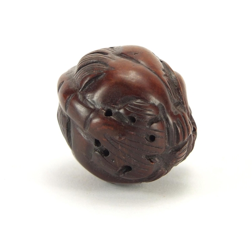 412 - Chinese carved wood Netsuke of a mythical animal and a silver coloured metal ring