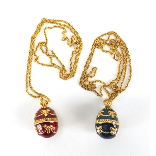 244 - Two gilt metal enamelled egg pendants on chains, 3cm in length