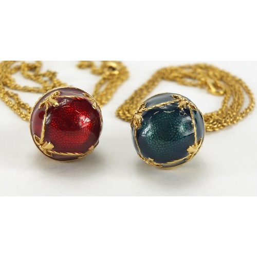 244 - Two gilt metal enamelled egg pendants on chains, 3cm in length