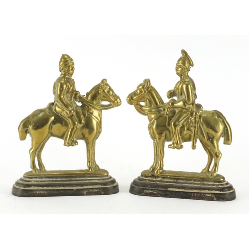 68 - Pair of brass guards on horseback doorstops, 25cm high