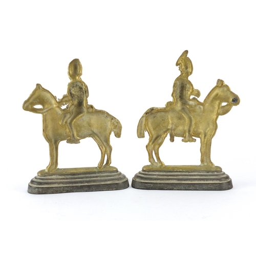 68 - Pair of brass guards on horseback doorstops, 25cm high
