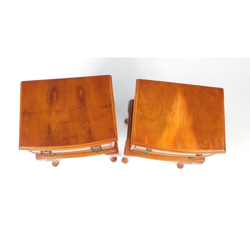 25 - Two yew bow front bedside chests, raised on cabriole legs, 66cm H x 42cm W x 33cm D