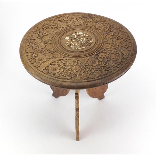 42 - Indonesian carved folding occasional table, with bone inlay, 35cm high x 30cm in diameter