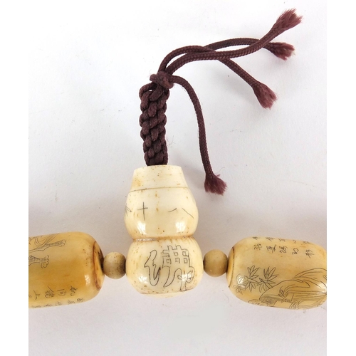 230 - Chinese bone bead necklace, incised with figures, animals and calligraphy, 60cm in length