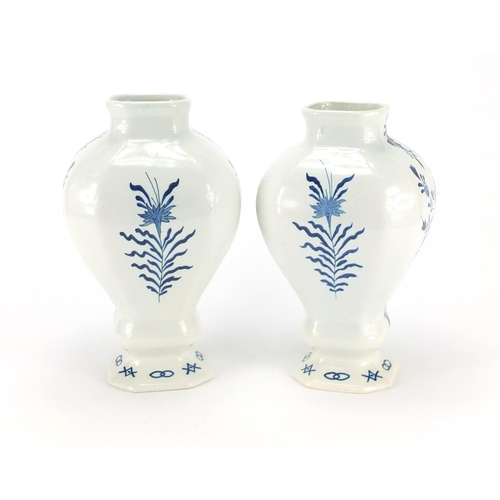 2078 - Two Delft pottery vases, hand painted with a windmill and church, the largest 27cm high