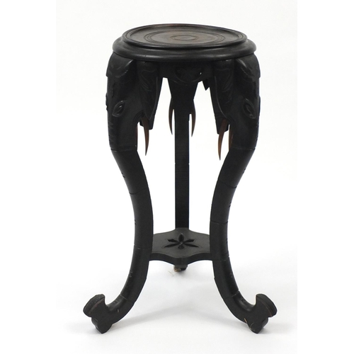 25A - Ebonised African plant stand with elephant head supports, 75cm high