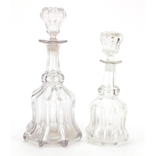 64 - Two cut glass decanters, the largest 33cm high