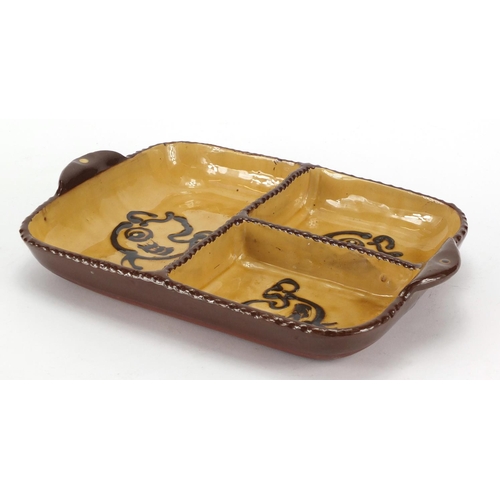 114 - Slipware pottery trefoil dish decorated with fish, 29cm in wide