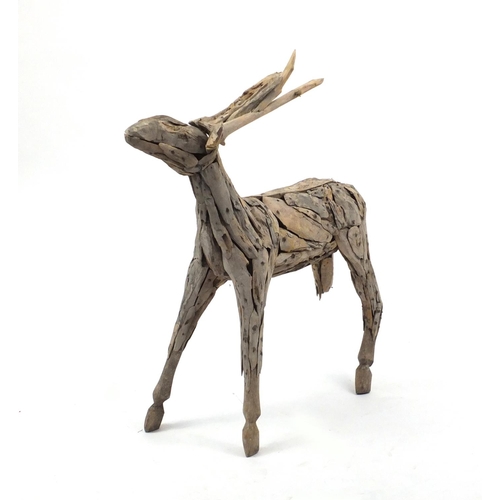 27 - Naturalistic wooden model of a deer, 107cm high