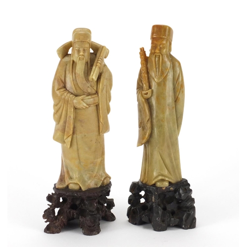 92 - Two Chinese carved soapstone figures holding objects, each 20.5cm high