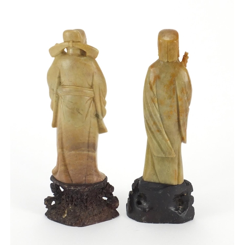 92 - Two Chinese carved soapstone figures holding objects, each 20.5cm high