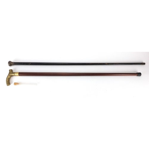 287 - Two walking sticks, one with drinking vessel the other with silver pommel, the largest 90cm in lengt... 