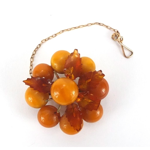 221 - Butterscotch amber coloured flower head brooch, 3.5cm in diameter, approximate weight 9.8g