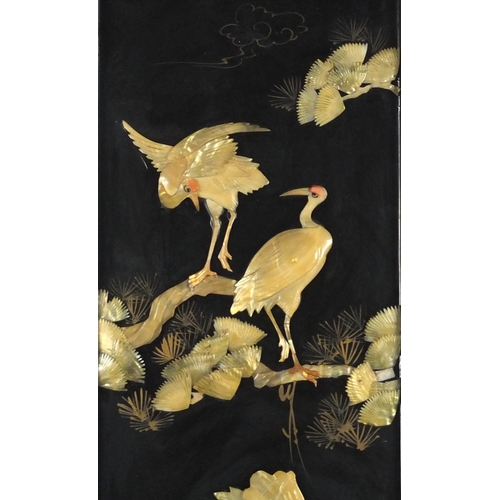 2094 - Three Oriental black lacquered panels with relief Mother of Pearl, decorated with birds of paradise ... 