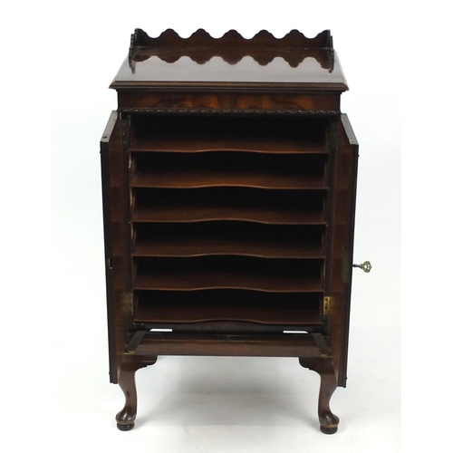 2007 - Waring & Gillow Ltd walnut music cabinet, the mechanical action doors with quarter veneer, raised on... 
