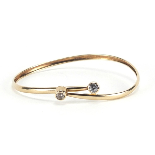 2278 - 9ct gold bangle set with clear stones, 6cm in diameter, approximate weight 2.7g