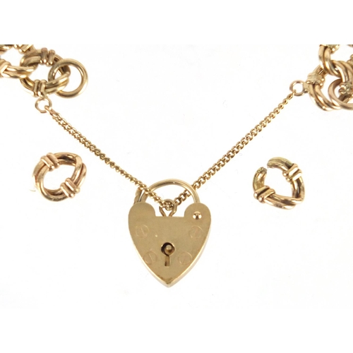 2259 - 9ct gold stylish link bracelet with love heart shaped padlock and spare links, 18cm in length, appro... 