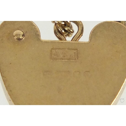 2259 - 9ct gold stylish link bracelet with love heart shaped padlock and spare links, 18cm in length, appro... 