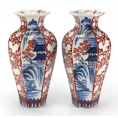 130 - Pair of Japanese hexagonal porcelain vases, decorated with landscapes and tress, 31cm high
