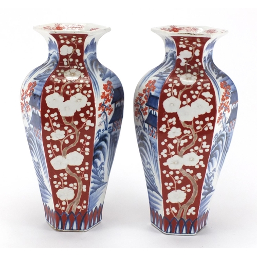 130 - Pair of Japanese hexagonal porcelain vases, decorated with landscapes and tress, 31cm high