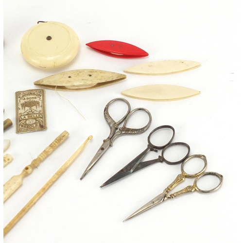 384 - Sewing objects including Dean Bakelite tape measure, bone cotton winders and Mother of Pearl handled... 