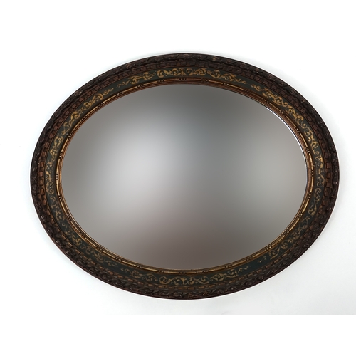 78 - Mahogany framed oval mirror with hand painted and gilded decoration, 71cm x 59cm