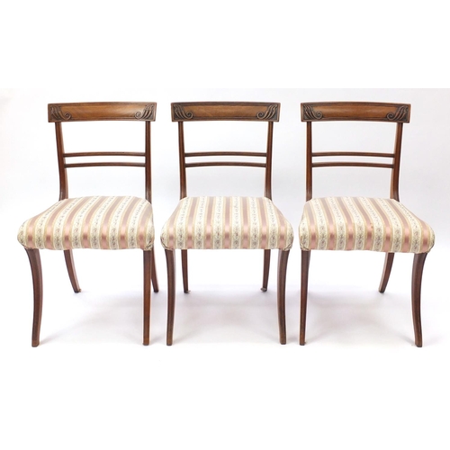 37 - Set of six Regency mahogany dining chairs, with carved top rails and striped upholstered stuff over ... 