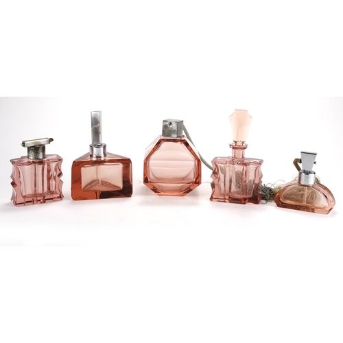 2144 - Art Deco peach glass dressing table items including scent bottle and atomisers, the largest 17cm hig... 