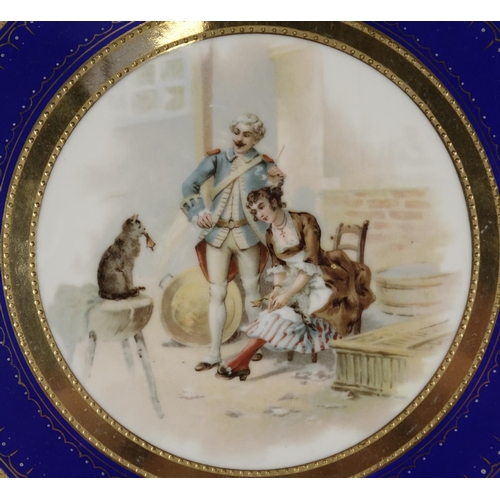 2127 - Vienna style porcelain tray with twin handles, decorated with two figures and a cat, 33cm in diamete... 