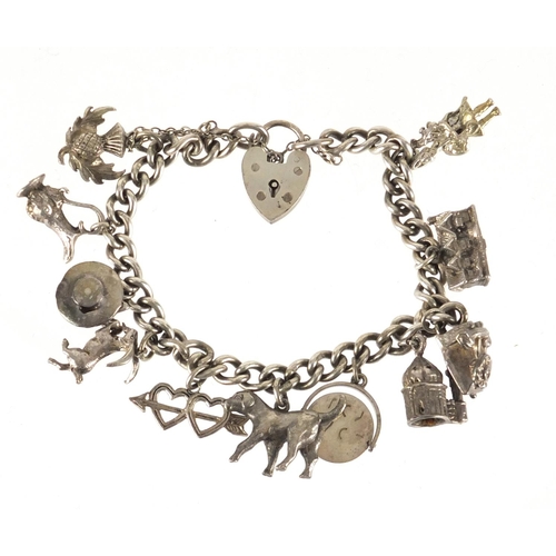 2381 - Silver charm bracelet with a selection of mostly silver charms, including dog, telephone and I Love ... 
