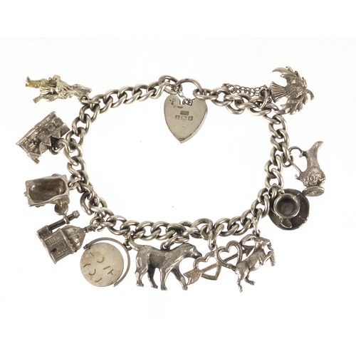 2381 - Silver charm bracelet with a selection of mostly silver charms, including dog, telephone and I Love ... 