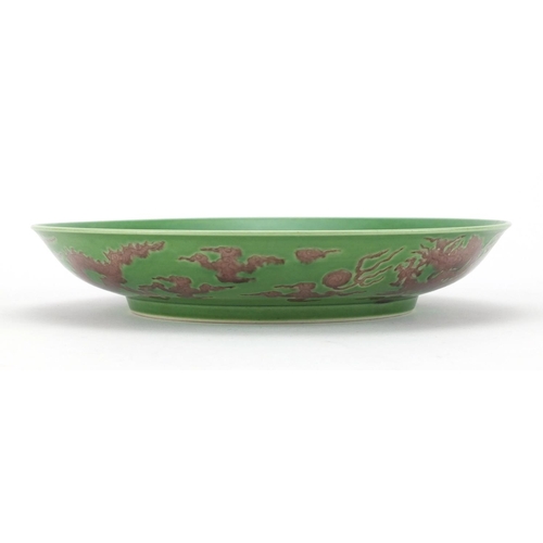 280 - Chinese green ground porcelain dish, hand painted with three dragons amongst clouds chasing the flam... 