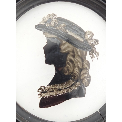 35 - 19th century reverse glass hand painted silhouette of a female, housed in an ebonised frame, the sil... 