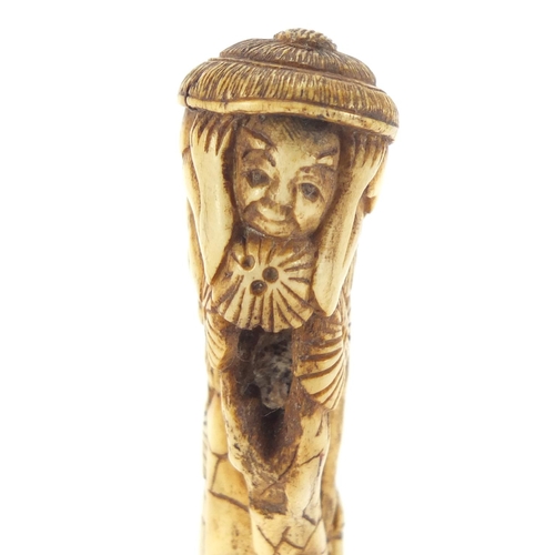 357 - Chinese bone parasol handle carved with two figures and trees, 16cm in length