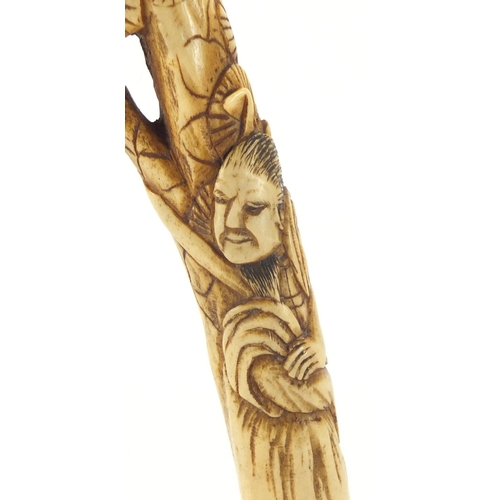 357 - Chinese bone parasol handle carved with two figures and trees, 16cm in length