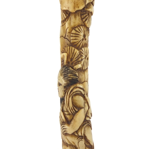 357 - Chinese bone parasol handle carved with two figures and trees, 16cm in length