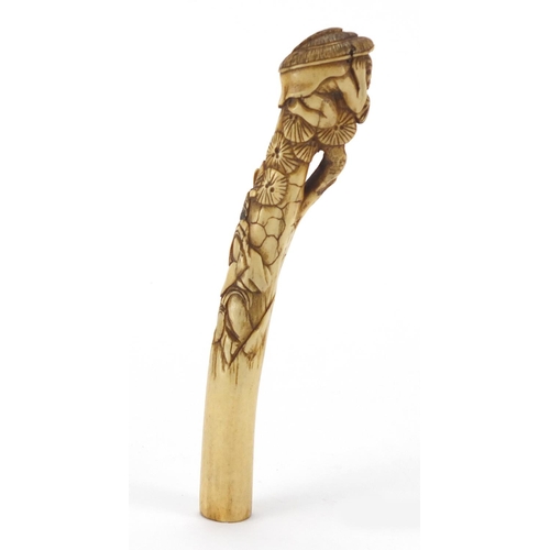 357 - Chinese bone parasol handle carved with two figures and trees, 16cm in length