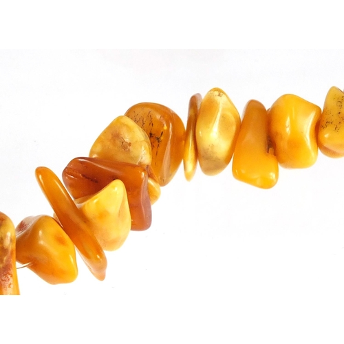 765 - Butterscotch and natural amber coloured necklace, 60cm in length, approximate weight 59.0g
